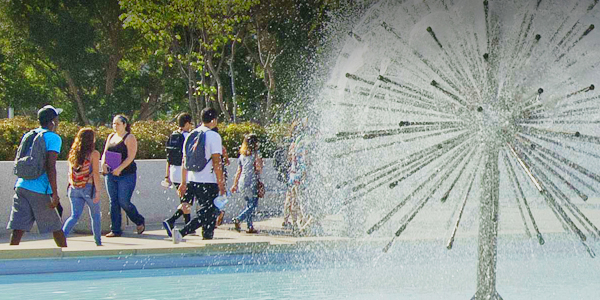 Students walking on the ɫ campus by the Brotman Fountain