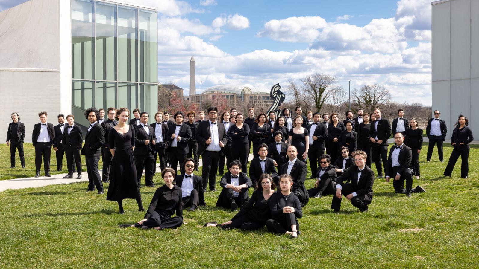 ɫ Wind Symphony Members pose on a grass lawn in Washington D.C.